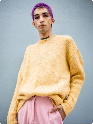 man in yellow sweater and pink pants