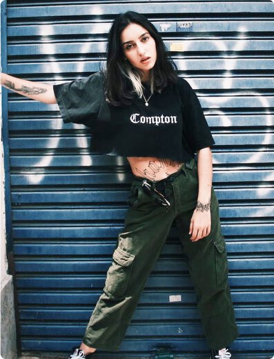 woman in cropped shirt and cargo pants
