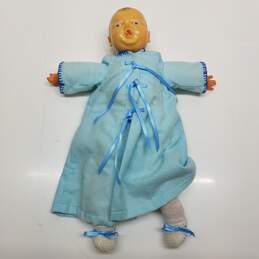 Vintage unmarked newborn baby doll in blue dress and diaper