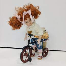 Geppeddo USA Molly Porcelain Doll with Bear Riding Tricycle