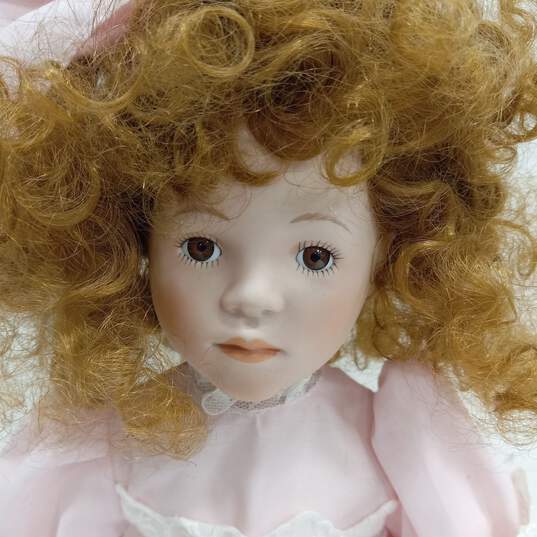 Dynasty Doll Collection Porcelain Doll With Strawberry Blonde Curly Hair And Brown Eyes In Pink Outfit image number 2