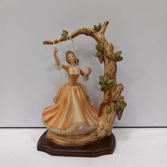 Vintage Lady on Swing Porcelain figure on Wooden Stand image number 1