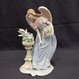 Figurine of Women With Wings Looking At Dove