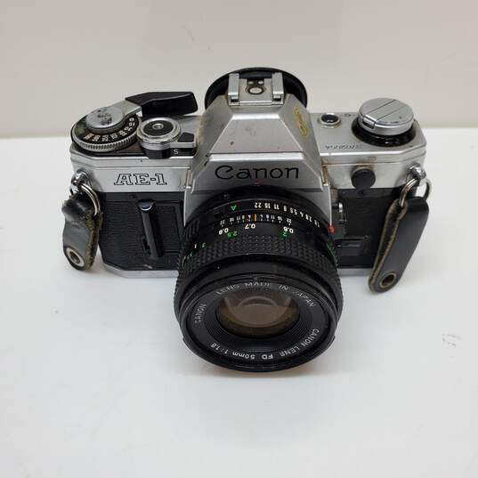 UNTESTED Sliver/Black Canon AE-1 Film Camera Bundle with 3 lenses, Flash & Bag image number 2