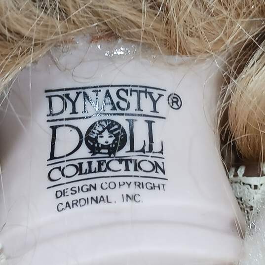 Dynasty Doll Collection Porcelain (Music Box Inside) Doll With Blonde Curly Hair, Blue Eyes, And Yellow Outfit image number 4