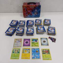 Lot of Assorted Pokemon Trading Cards In Tin