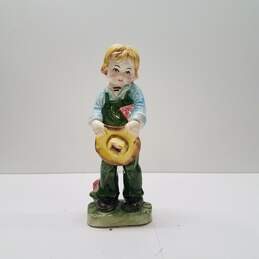 Porcelain Young Boy with Overalls and Hat Figurine