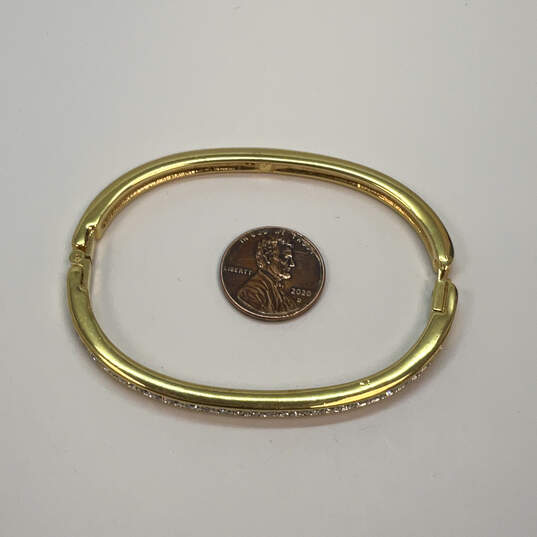 Designer Swarovski Gold-Tone White Rhinestone Hinged Bangle Bracelet image number 3