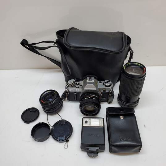 UNTESTED Sliver/Black Canon AE-1 Film Camera Bundle with 3 lenses, Flash & Bag image number 1