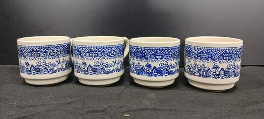 Bundle of 4 Vintage White and Blue Ceramic Stacking Tea Cups image number 1
