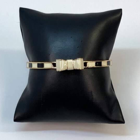Designer Kate Spade Gold-Tone Bow Tie Band Bangle Bracelet 20.6g image number 1