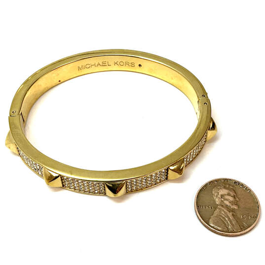 Designer Michael Kors Gold-Tone Rhinestone Studded Hinged Bangle Bracelet image number 3