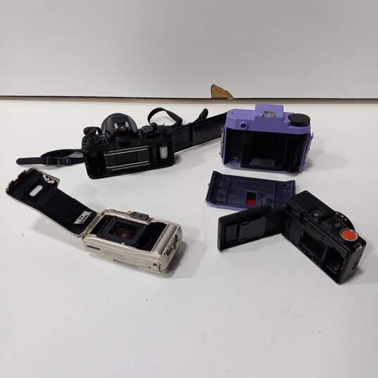 Bundle of 4 Assorted Cameras, Lenses, Flashes & Accessories In Purple Carrying Case image number 5