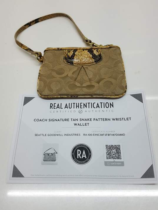 AUTHENTICATED Coach Signature Tan Snake Pattern Wristlet Wallet image number 1