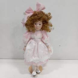 Dynasty Doll Collection Porcelain Doll With Strawberry Blonde Curly Hair And Brown Eyes In Pink Outfit