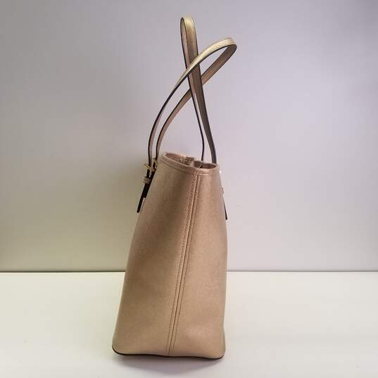 Buy the Michael Kors Saffiano Leather Tote Bag Gold