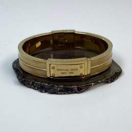Designer Michael Kors Gold Tone Heritage Logo Hinged Bangle Bracelet