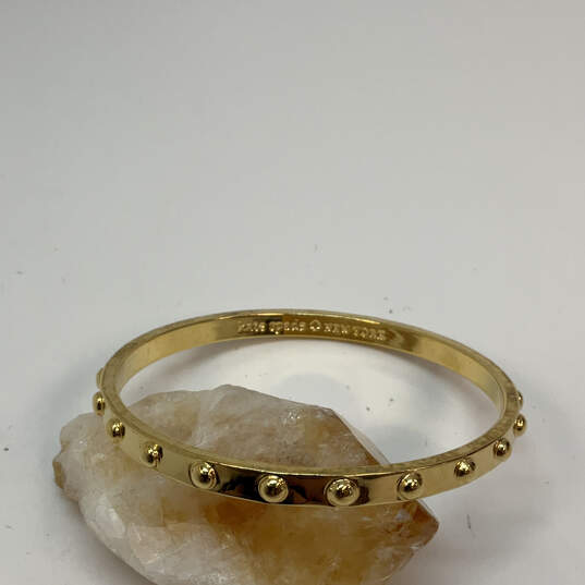 Designer Kate Spade Gold-Tone Studded Notched Classic Bangle Bracelet image number 1