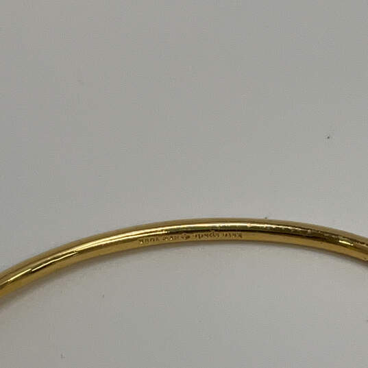 Designer Kate Spade Gold-Tone Fashionable Hinged Clasp Cuffed Bracelet image number 4