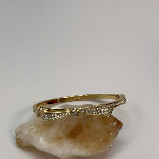 Designer Kate Spade Gold-Tone Hinged Pave Crystal Stone Bow Bangle Bracelet image number 1
