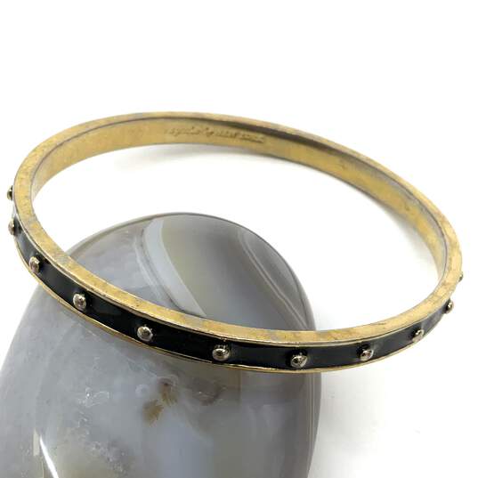 Designer Kate Spade Gold-Tone Black Fashionable Rivet Bangle Bracelet image number 1