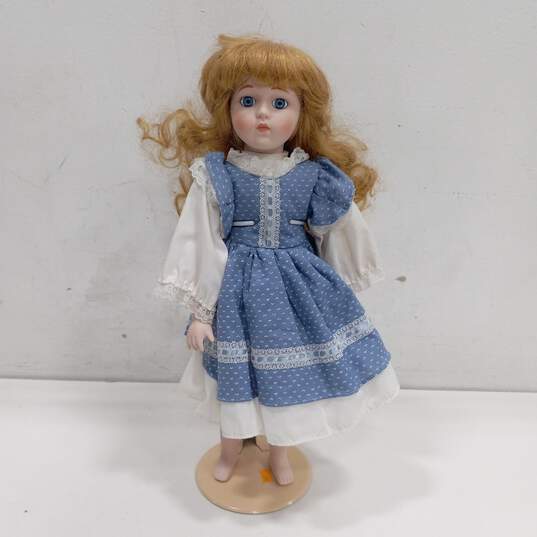 Dynasty Doll Collection Porcelain Doll With Curly Blonde Hair And Blue Eyes In Blue And White Dress image number 1
