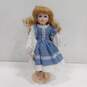 Dynasty Doll Collection Porcelain Doll With Curly Blonde Hair And Blue Eyes In Blue And White Dress image number 1