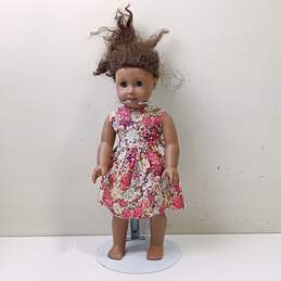American Girl Doll With Brown Skin & Hair, Green Eyes, Curly Hair, And In Flower Dress