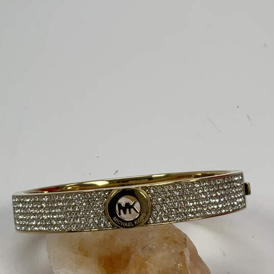 Designer Michael Kors Gold-Tone Shiny Rhinestone Hinged Bangle Bracelet image number 1