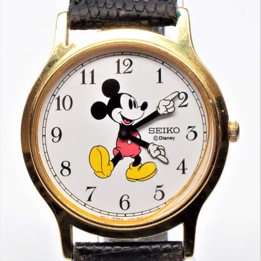 Buy the Seiko Disney Mickey Mouse V700-8A10 Gold Tone Case Black Leather  Band Watch w/Box | GoodwillFinds