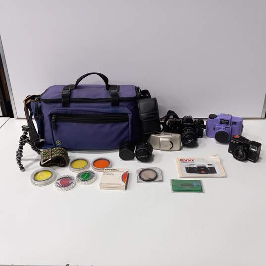 Bundle of 4 Assorted Cameras, Lenses, Flashes & Accessories In Purple Carrying Case image number 1