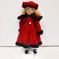 Unbranded Porcelain Doll With Blue Eyes, Curly Blonde Hair, Multicolor Plaid Dress, Red Coat And Hat, Black Shoes, And White Socks And Bloomers image number 1