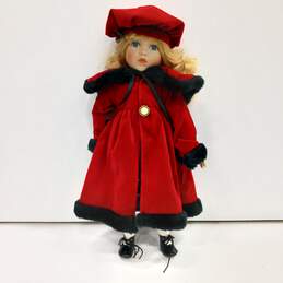 Unbranded Porcelain Doll With Blue Eyes, Curly Blonde Hair, Multicolor Plaid Dress, Red Coat And Hat, Black Shoes, And White Socks And Bloomers