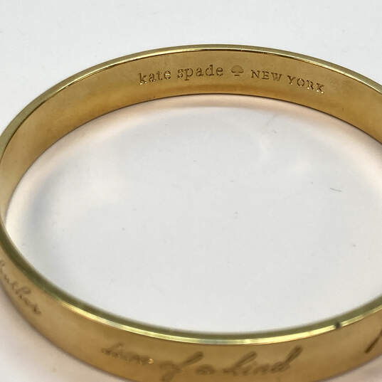 Kate Spade New York Gold-Tone Round Shape Engraved Bangle Bracelet image number 4