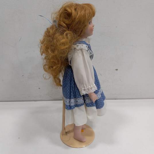 Dynasty Doll Collection Porcelain Doll With Curly Blonde Hair And Blue Eyes In Blue And White Dress image number 3