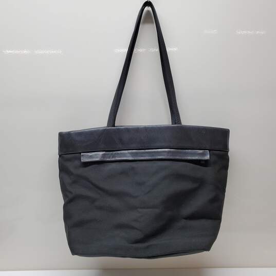 TUMI Large Travel Tote in Black with Black Leather Detail & Trim image number 1
