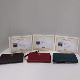 3pc Set of Authenticated Women's Coach Signature Canvas Zip Around Wallets
