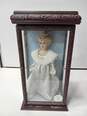 VINTAGE 2000 CAMELLIA GARDENS COLLECTION 16" PORCELAIN DOLL IN WOOD AND GLASS CASE WITH SWAROVSKI COMPANY NECKLACE AND EARRINGS image number 1