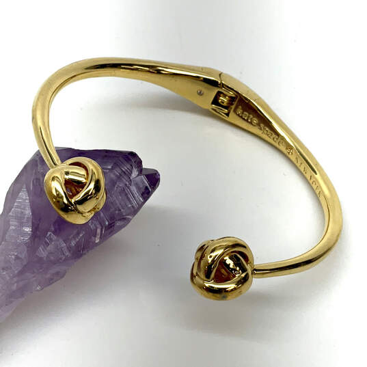 Designer Kate Spade Gold-Tone Hinged Knot Adjustable Cuff Bracelet image number 1