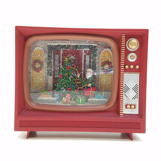 Raz Imports Santa Decorating Tree Light Up TV Snow Globe image number 1