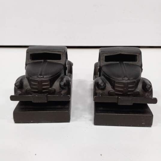 Pair of Black Pickup Truck Painted Pewter Paperweights image number 1