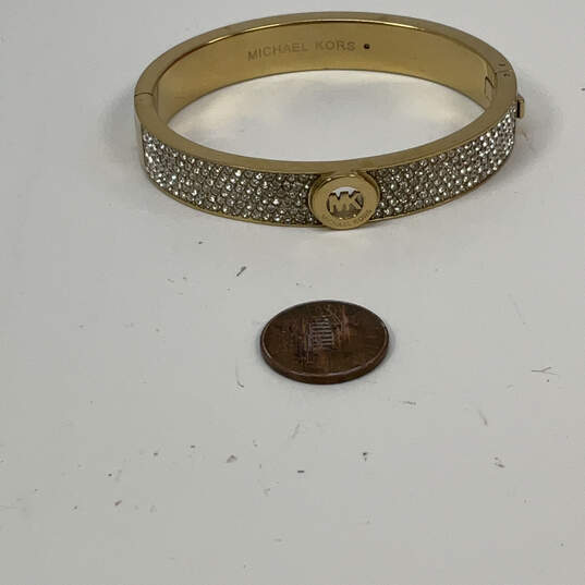 Designer Michael Kors Gold-Tone Shiny Rhinestone Hinged Bangle Bracelet image number 3