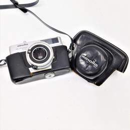 Minolta Autopak 700 Film Camera w/ Rokkor 38mm Lens  Half Dollar in Box w/COA