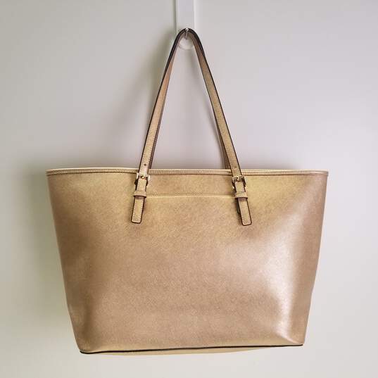 Buy the Michael Kors Saffiano Leather Tote Bag Gold