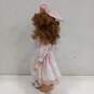 Dynasty Doll Collection Porcelain Doll With Strawberry Blonde Curly Hair And Brown Eyes In Pink Outfit image number 5