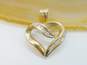 10K Yellow Gold Diamond Round & Baguette Accents Ribbon Heart Pendant 1.5g image number 1