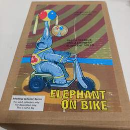 Elephant On Bike Figurine