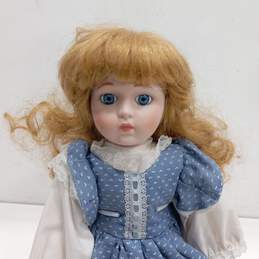 Dynasty Doll Collection Porcelain Doll With Curly Blonde Hair And Blue Eyes In Blue And White Dress alternative image
