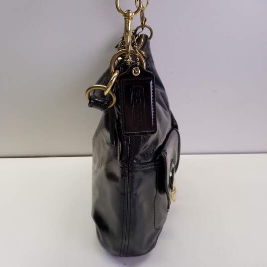 Buy the COACH F23401 Daisy Liquid Black Patent Leather Pocket