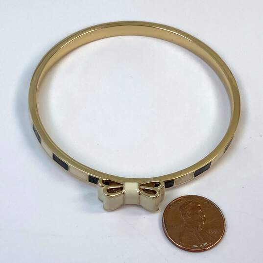 Designer Kate Spade Gold-Tone Bow Tie Band Bangle Bracelet 20.6g image number 2